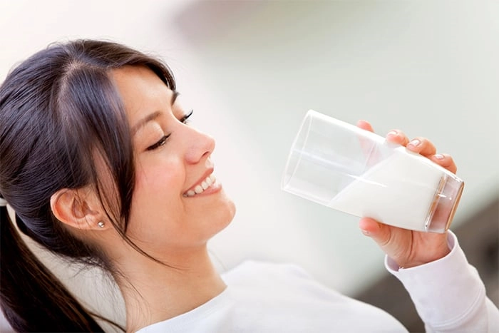 a woman drinking milk
